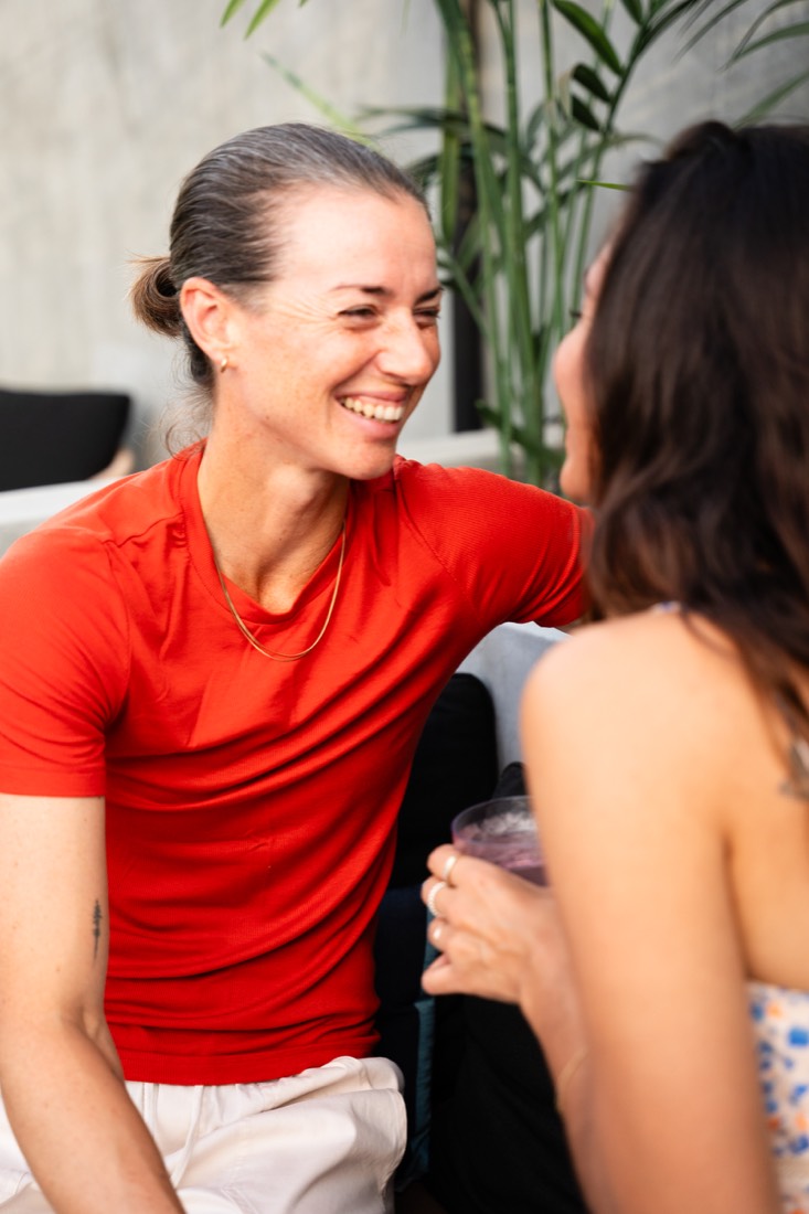 Two women sharing a laugh on a patio
